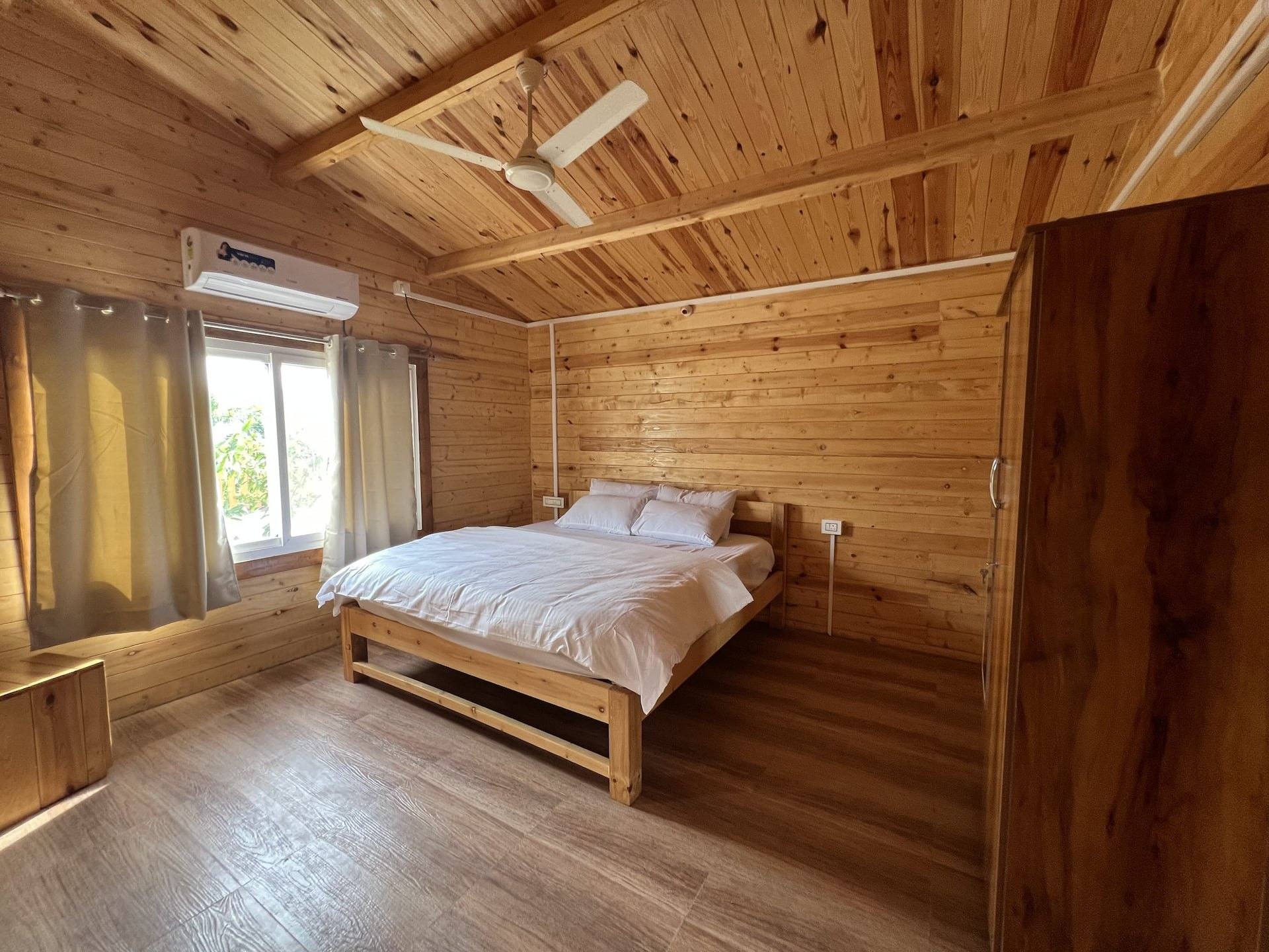 Bedroom with a king bed and pine-panelled walls