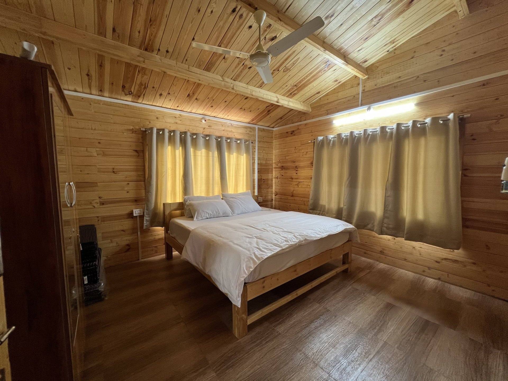 Second bedroom with a king bed and curtained windows