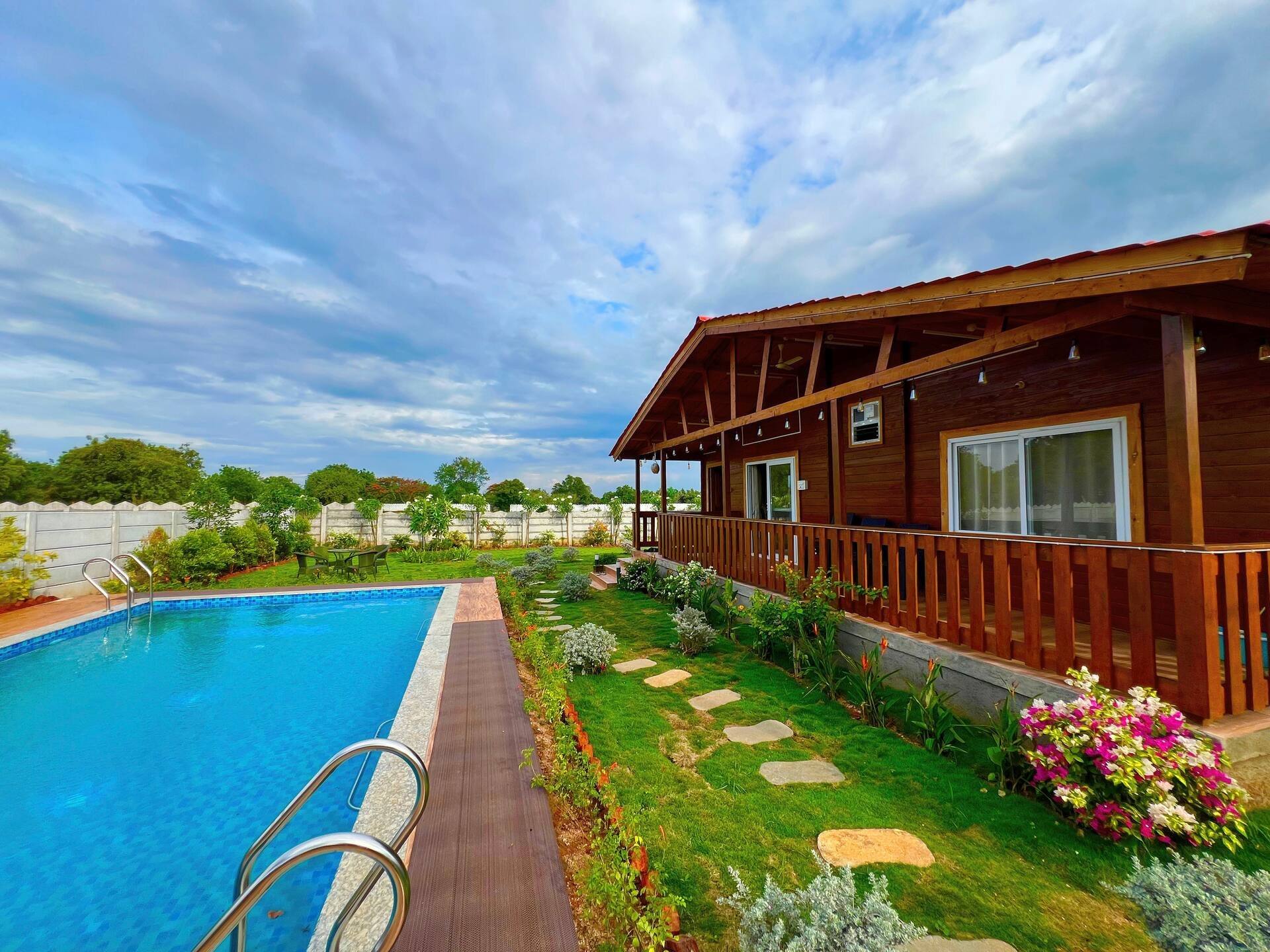 Wooden cottage beside the pool and stepping-stone path