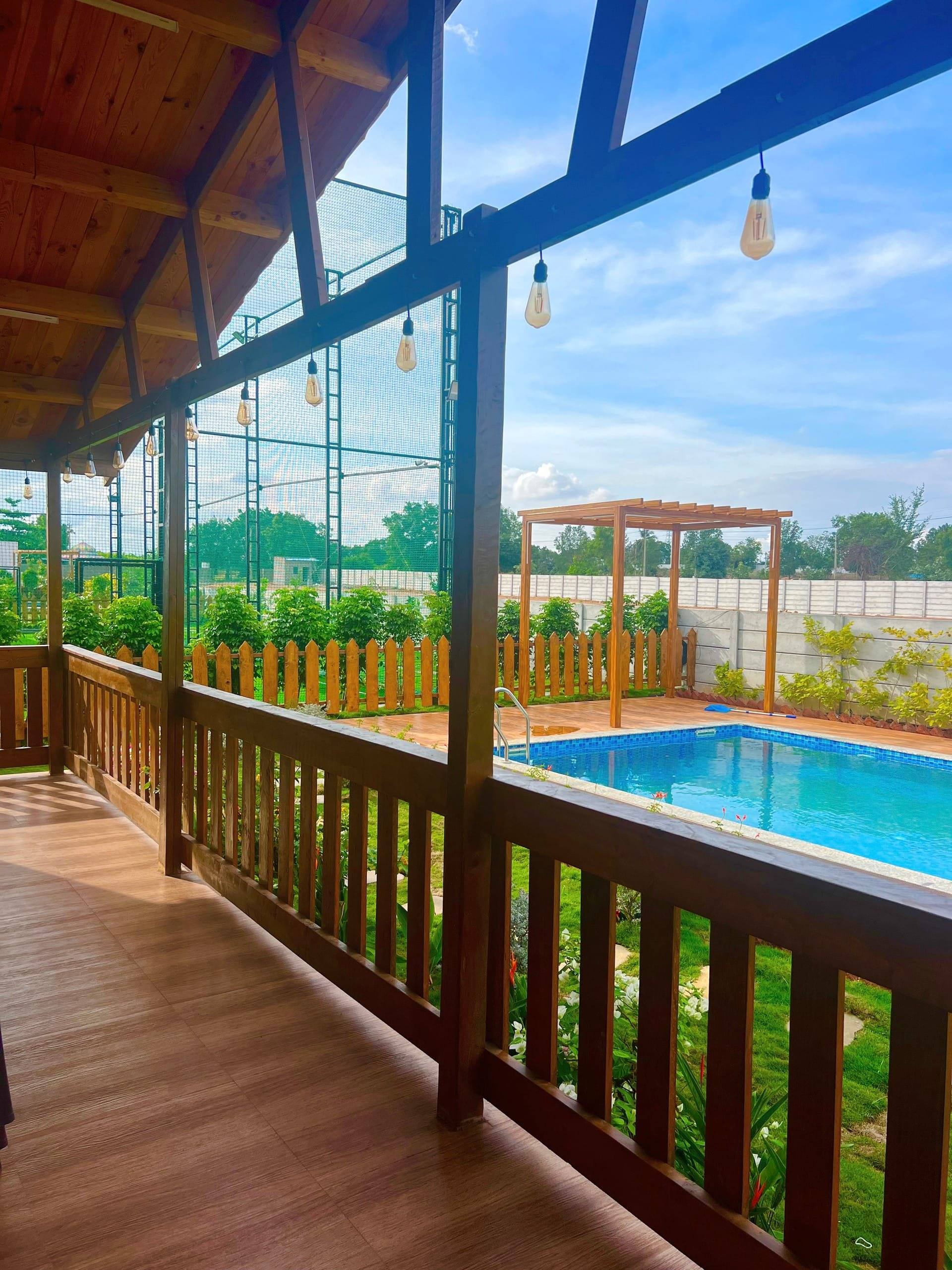 Wooden deck and railing overlooking the pool