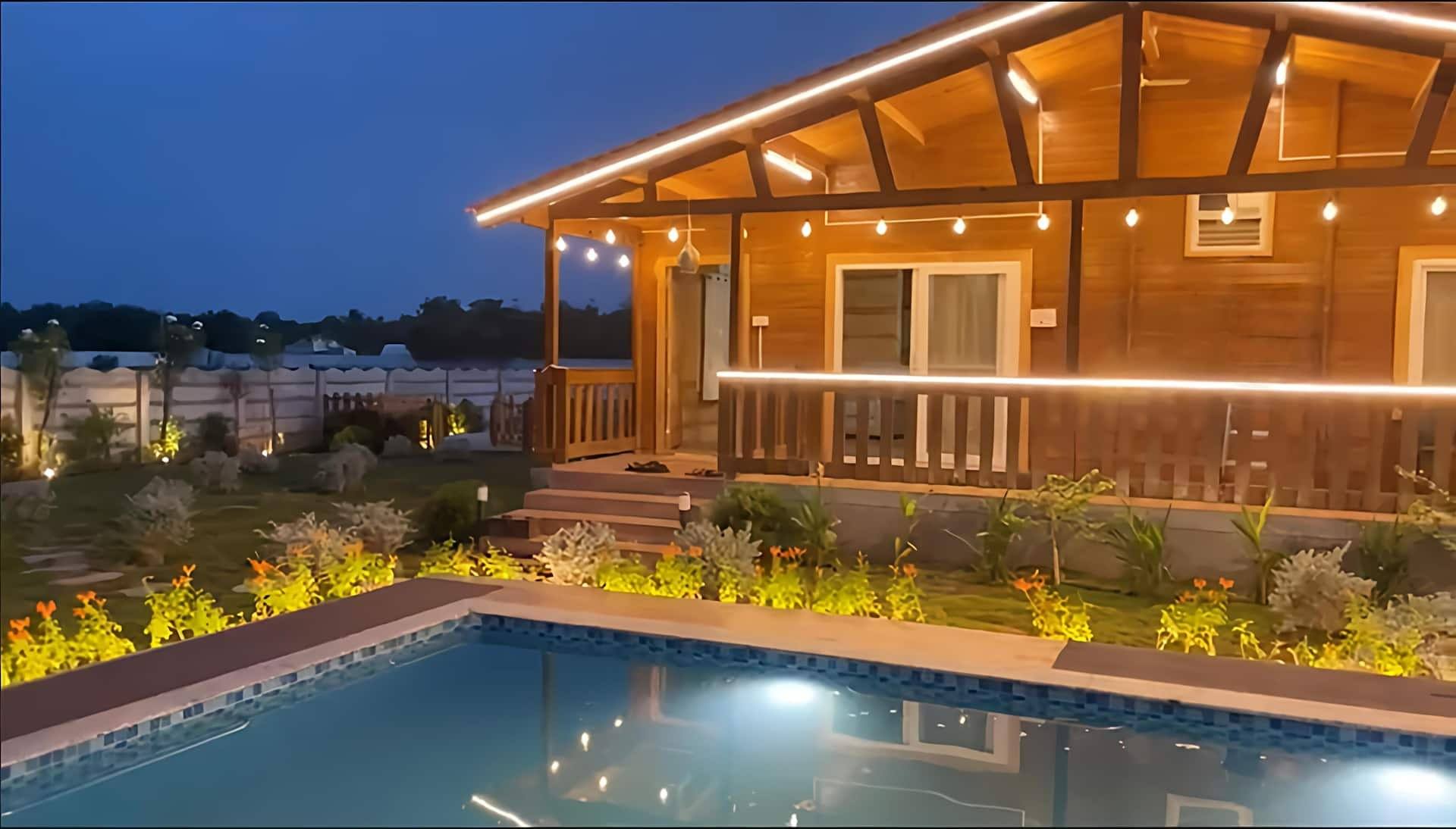 Cottage and pool glowing after sunset